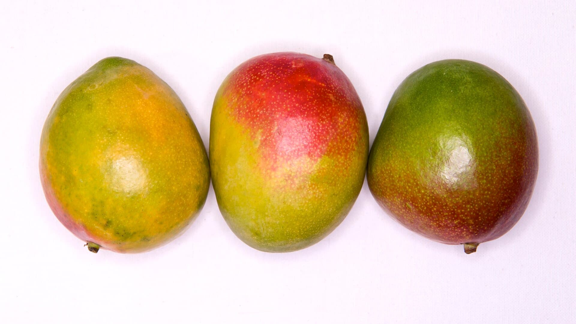 Three whole ripe mangoes